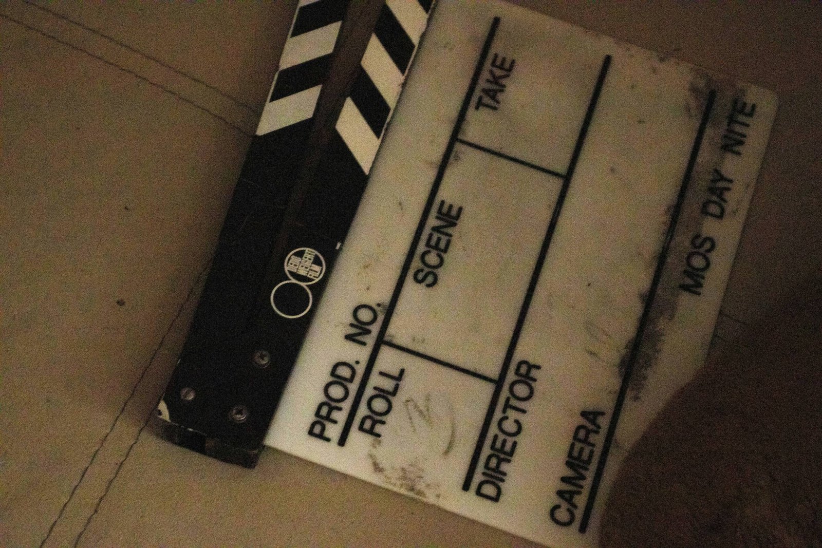 A close up of a movie clapper on the ground